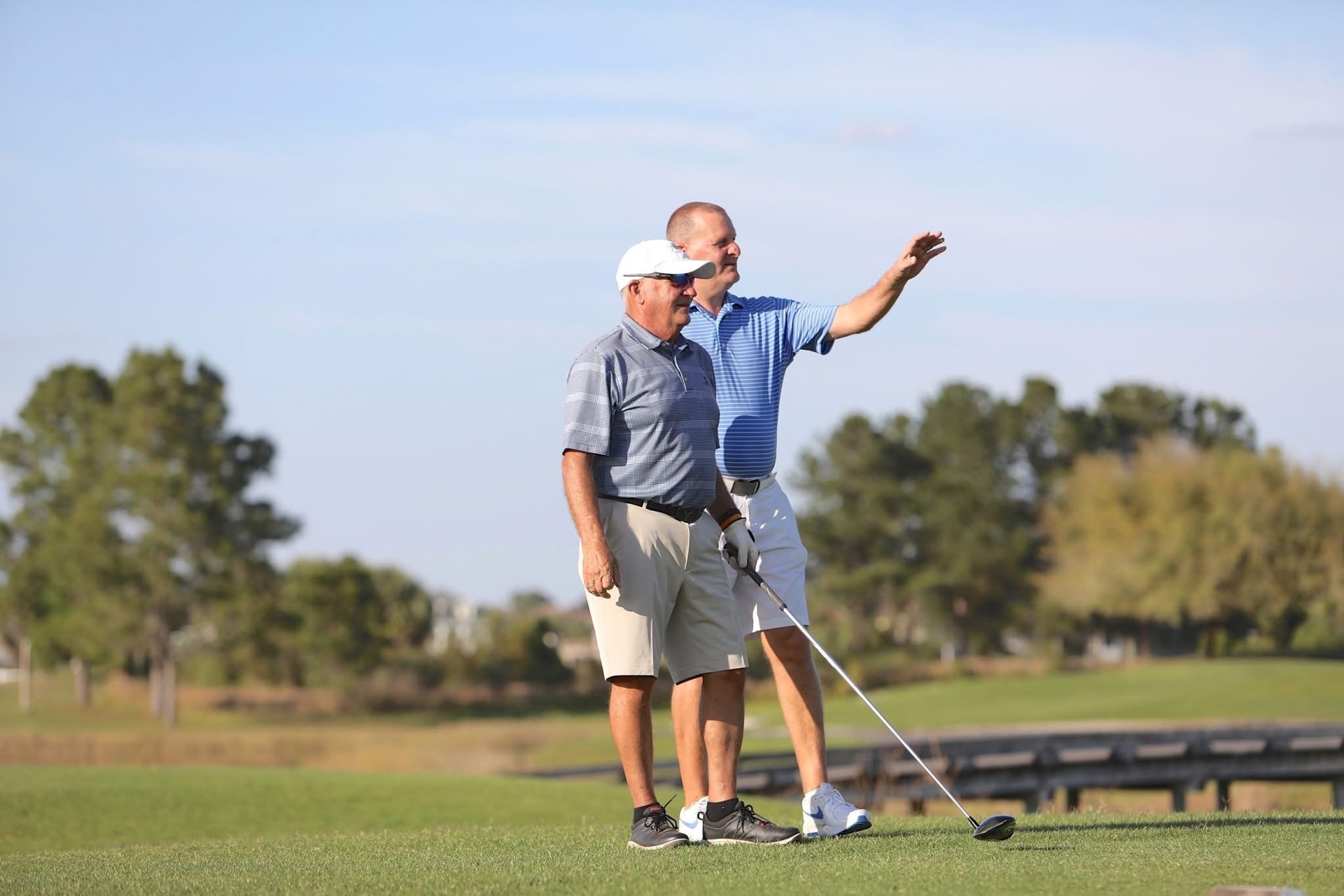 Steve Miller coaching beside a golfer at Harmony